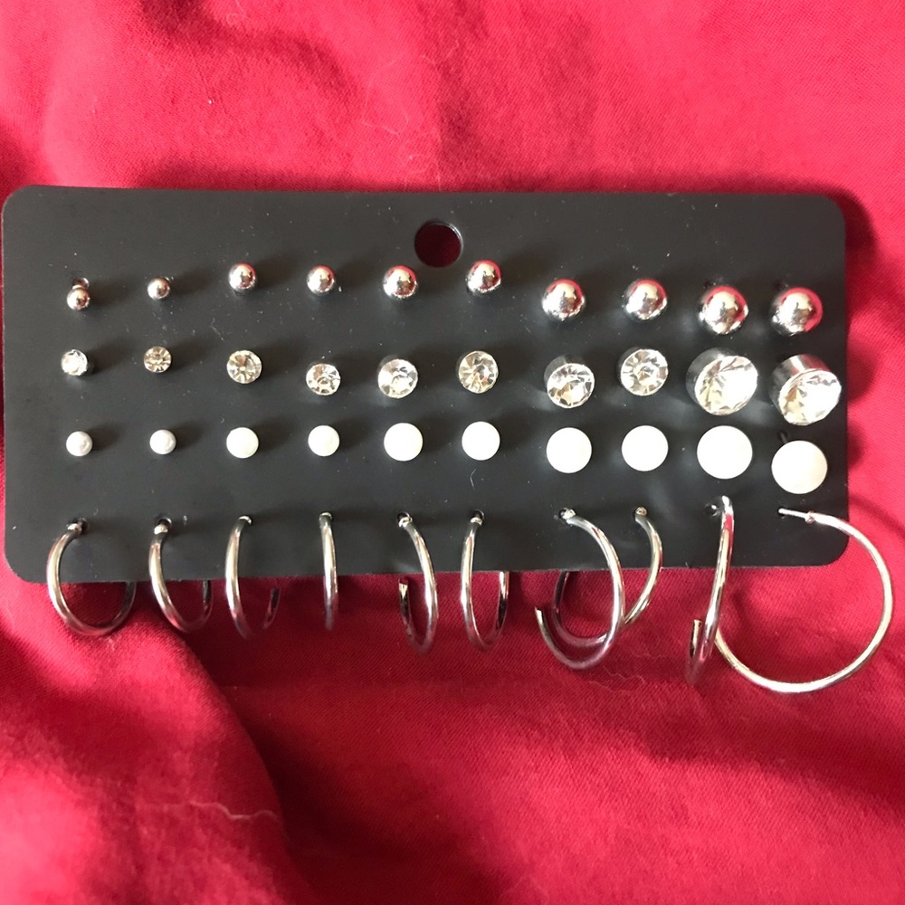 20 pair of silver tone, crystal, pearl like and hoop earrings.